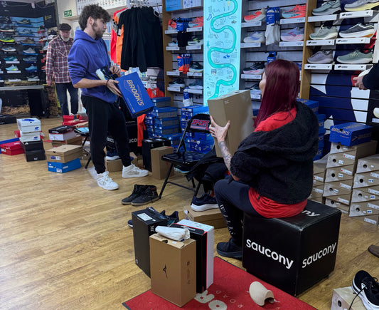 Picture of Sportlink staff helping customer choose running trainers